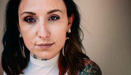 Offbeat close-up portrait of a woman of unusual style. People with tattoos. Tattooed girl of unusual style. Eccentric lady with a depressed appearance.の素材