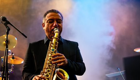 Saxophonist playing his saxophone on a smoky stageの素材
