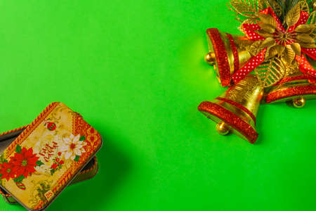 green christmas background with bell, candle, gift box, little snow manの写真素材
