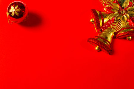 red christmas background decoration of bells gift box, red and golden wreath, christmas balls