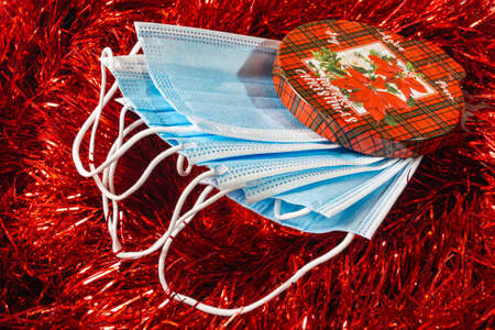 red christmas background decoration of bells gift box, red and golden wreath, christmas balls and flowersの写真素材