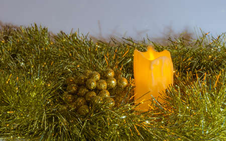 white christmas background with red golden wreath, christmas ball and bells, candle and flowersの写真素材