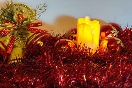 white christmas background with red golden wreath, christmas ball and bells, candle and flowersの写真素材