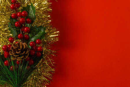 red christmas background decoration of bells gift box, red and golden wreath, christmas balls and flowersの写真素材