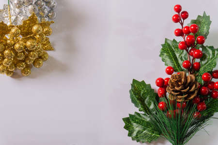 white christmas background with red golden wreath, christmas ball and bells, candle and flowersの写真素材