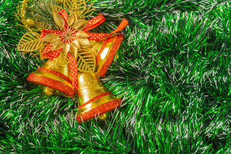 green christmas background with golden red bellsの写真素材