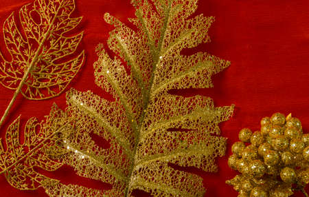 red christmas background decoration of bells gift box, red and golden wreath, christmas balls and flowersの写真素材