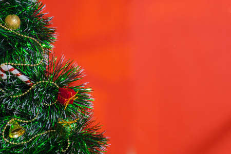 red christmas background decoration of bells gift box, red and golden wreath, christmas balls and flowersの写真素材