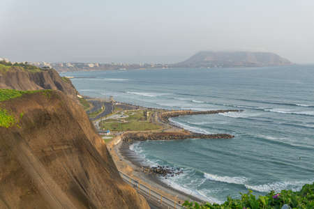 View of the ocean from the Miraflores District Peru, a cliff, tree and green grassの写真素材