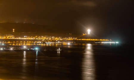 Night view of the ocean in Lima Peru, yellow lights in the highway, shore, long expositionの写真素材