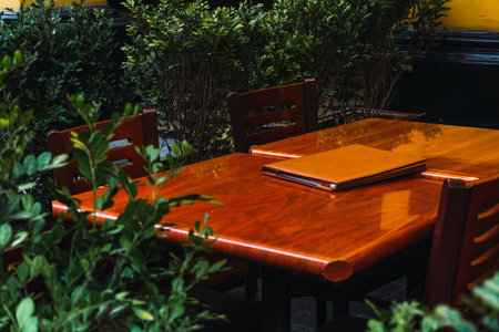 outdoor restaurant tables in historic center of Lima Peru, flowerpot around wooden tables