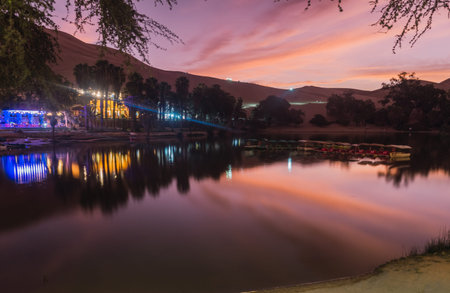 Beautiful sunset at Huacachina lagoon, Ica Peruの写真素材