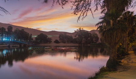 Beautiful sunset at Huacachina lagoon, Ica Peruの写真素材