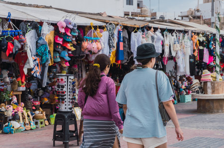 unrecognizable people walking in El Chaco boulevard, Ica Peru, looking for souvenirsの写真素材