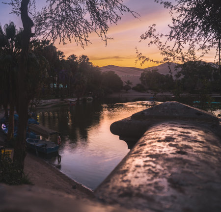 Beautiful sunset at Huacachina lagoon, Ica Peruの写真素材