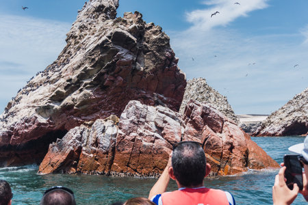 Unrecognizable people on boat sightseeing in the Ballestas Islands at Paracas, Ica Peruの写真素材
