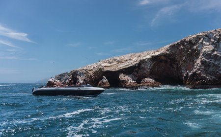 Unrecognizable people on boat sightseeing in the Ballestas Islands at Paracas, Ica Peruの写真素材