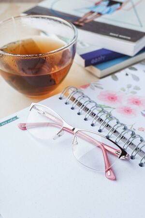 Woman glasses with tea and booksの写真素材