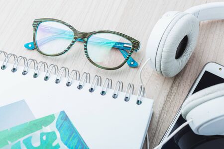 Woman glasses with phone and headphonesの写真素材