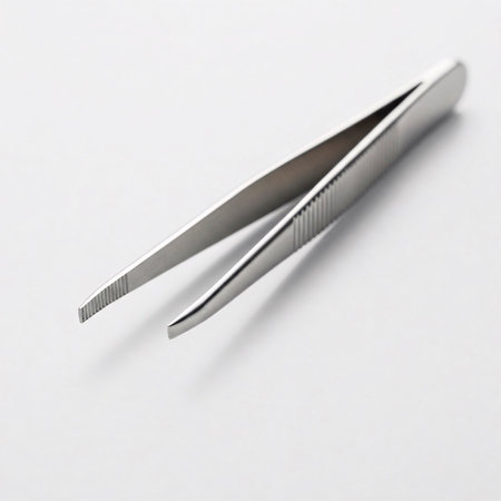Tweezers on a white background. Close-up photo.の素材