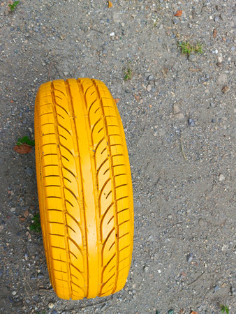 Yellow car tire on the ground. Close-up view.の写真素材