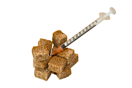 isolated brown sugar bricks and insuline syringeの写真素材