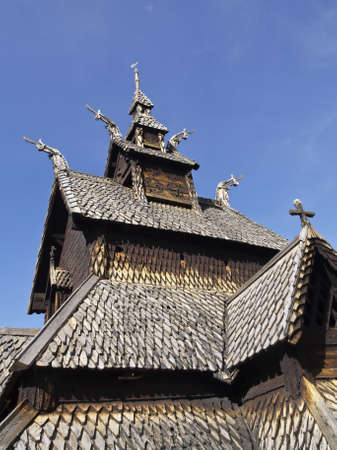 Top of a wooden church in Norway from the Middle Ages, with the roofs, crucifixes and Viking symbols の写真素材