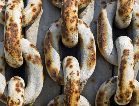 Three rows of large rusty iron chainsの写真素材