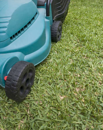 Close up image of a mower on the green grass of a gardenの写真素材