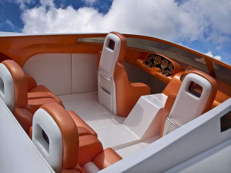 Interior of a luxury sport boat in bright colors on a blue sky with white cloudsの写真素材