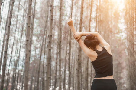 Beautiful sport young woman female lifestyle tired after running workout in forest nature park with copy spaceの写真素材