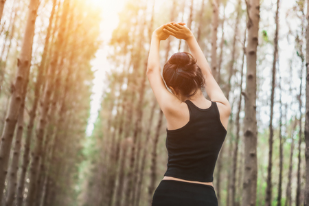 Blissful sporty woman enjoying freedom in nature. Outdoor healthy lifestyle concept.の写真素材