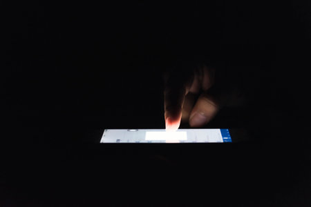Woman using her mobile phone, city skyline night light background