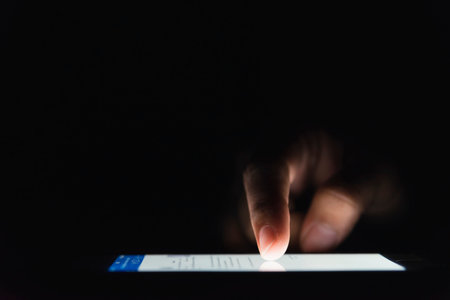 Female using smartphone on her bed in night time