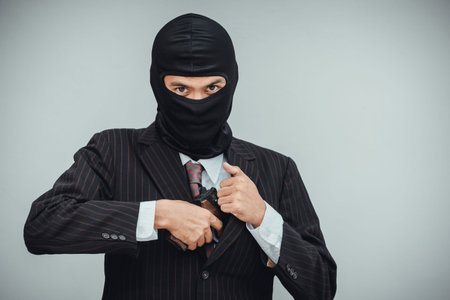 Mafioso in suit pulls out a gun before the bank robbery work