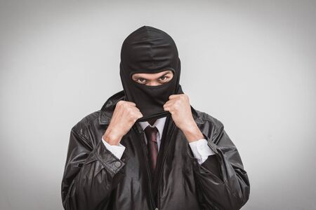 Businessman with mask hypocrisy conceptの写真素材
