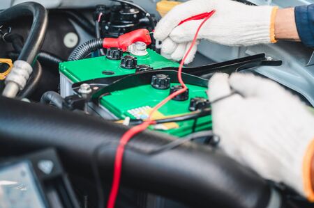 Hands of car mechanic working in auto repair service.の写真素材
