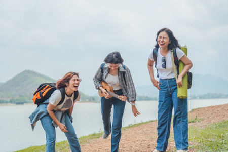 Jungle with friends. Group of young people with backpacks walking together and looking happyの写真素材