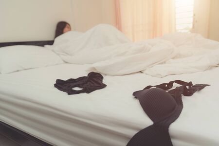 Bedroom mess with lingerie, shoes and condom, quick sex conceptの写真素材