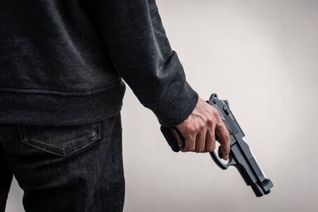 A man holding a gun in hand, the ship ready to shoot the man pointed a gun at us. A man holding a gun was robbed.の写真素材