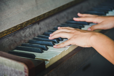 Close-up of a music performer's hand playing the pianoの写真素材