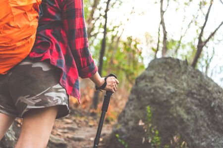 Hiking or running woman in beautiful mountains inspirational landscape. Sole of sports shoe and legs on rock trail. Hiker trekking or walking of footpath. Healthy fitness lifestyle outdoors.の写真素材