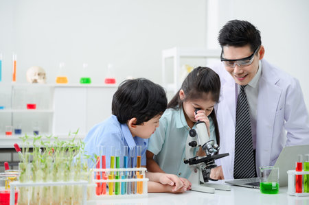 Kids learning about botany hands on. There is a diverse group of children gathered around a...
