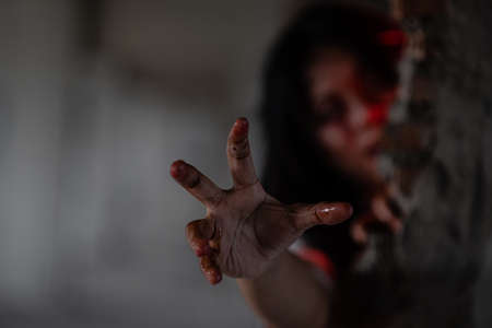 Close-up portrait of a scary bloody zombie girl. Horror. Halloween.の写真素材