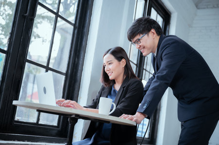 Both businessmen were overjoyed, leaving their laptops showing off their profitability goals.の写真素材