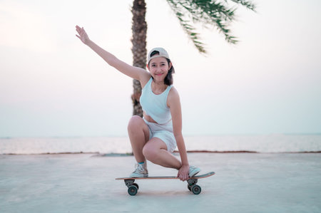 Portraits, Asian women skating on a beach with coconut trees at sunset.
