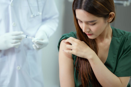 Doctors are injecting injections, vaccines, and female patients to build immunity and antivirals.の写真素材