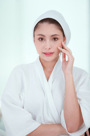 Beauty portrait. Skincare banner. Aesthetic cosmetology. Pensive woman with perfect face skin nude makeupの写真素材