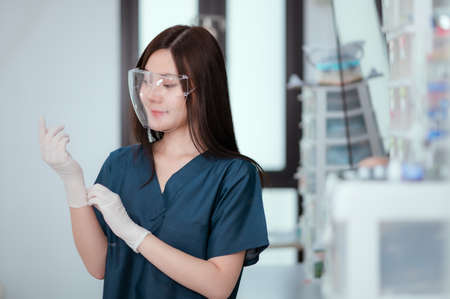Specialists are preparing for surgery, looking at a camera and wearing a surgical mask.の写真素材