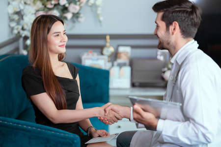 Doctor who specializes in cosmetic surgery is giving advice on how to improve the beauty of the face. And enhancing breasts and good proportionsの写真素材